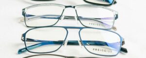 A close-up of modern Freigeist eyeglasses on a white surface.