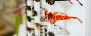 A vibrant assortment of fashionable sunglasses displayed on a store rack, ready for a trendy sale.