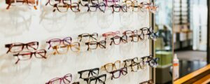 Colorful eyeglasses on display in a modern, well-lit eyewear store.
